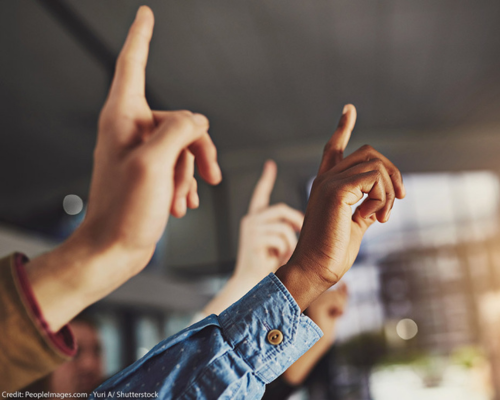 ACLU DEIA Blog_display Several hands raising, one of which belongs to a Black person.