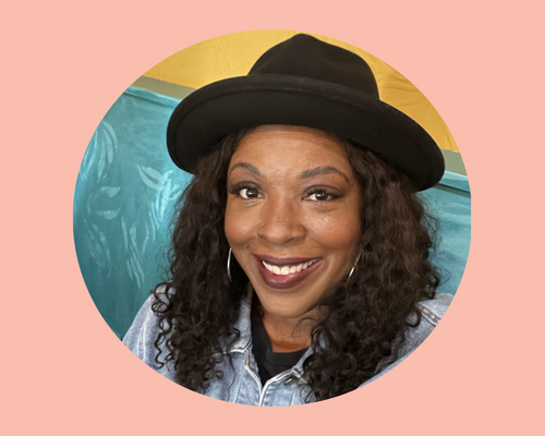 A circular photo of a smiling Black woman in a black hat set against a light pink background 