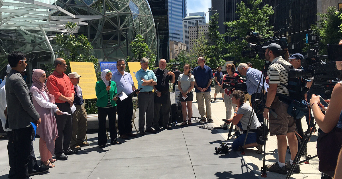 Photo of a press event outside Amazon's headquarters protesting the marketing of face surveillance systems to the government