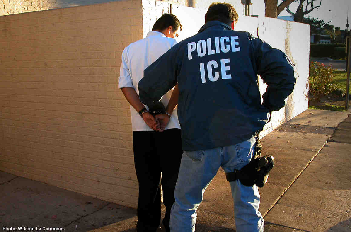 ICE officer arresting someone
