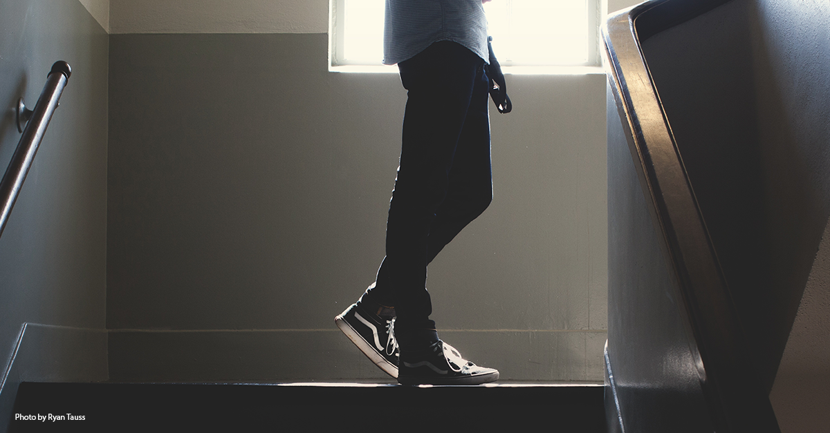 Photo of a student standing on a staircase