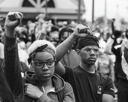 Photo of Black activists raising their right fists