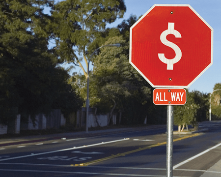 Photo of a stop sign with a dollar sign instead of the word stop
