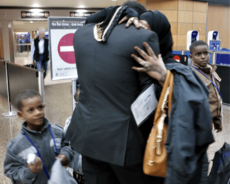 A photo of Joseph Doe reunited with his family