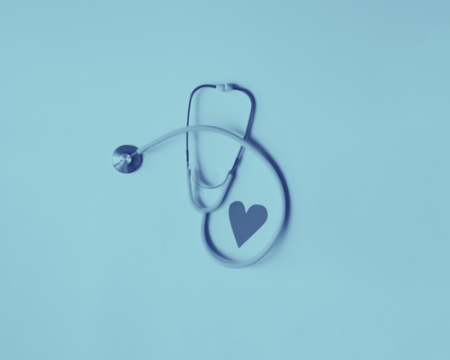 A light blue background with a blue stethoscope and a cut out paper heart