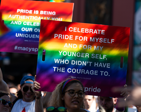 Sign in a pride parade that reads "I celebrate pride for myself and for my younger self who didn't have the courage to."