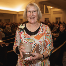 Nancy Talner smiling and holding the Kathleen Taylor Civil Libertarian award 
