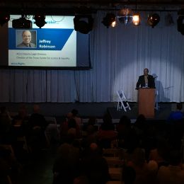 ACLU National Deputy Legal Director Jeffery Robinson at the podium at the February Flights and Rights Event