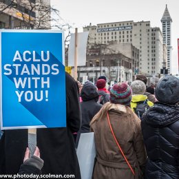 Photo of MLK marchers with ACLU stands with you signs and Black Lives Matter signs.  Photo credit Jim Scolman