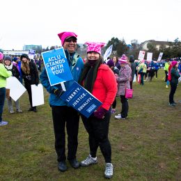 Marchers with a sign that says "The ACLU stands with you"