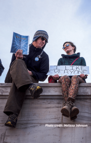 Photo of people holding signs outside