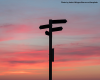 A photo of directional signs at a crossroads